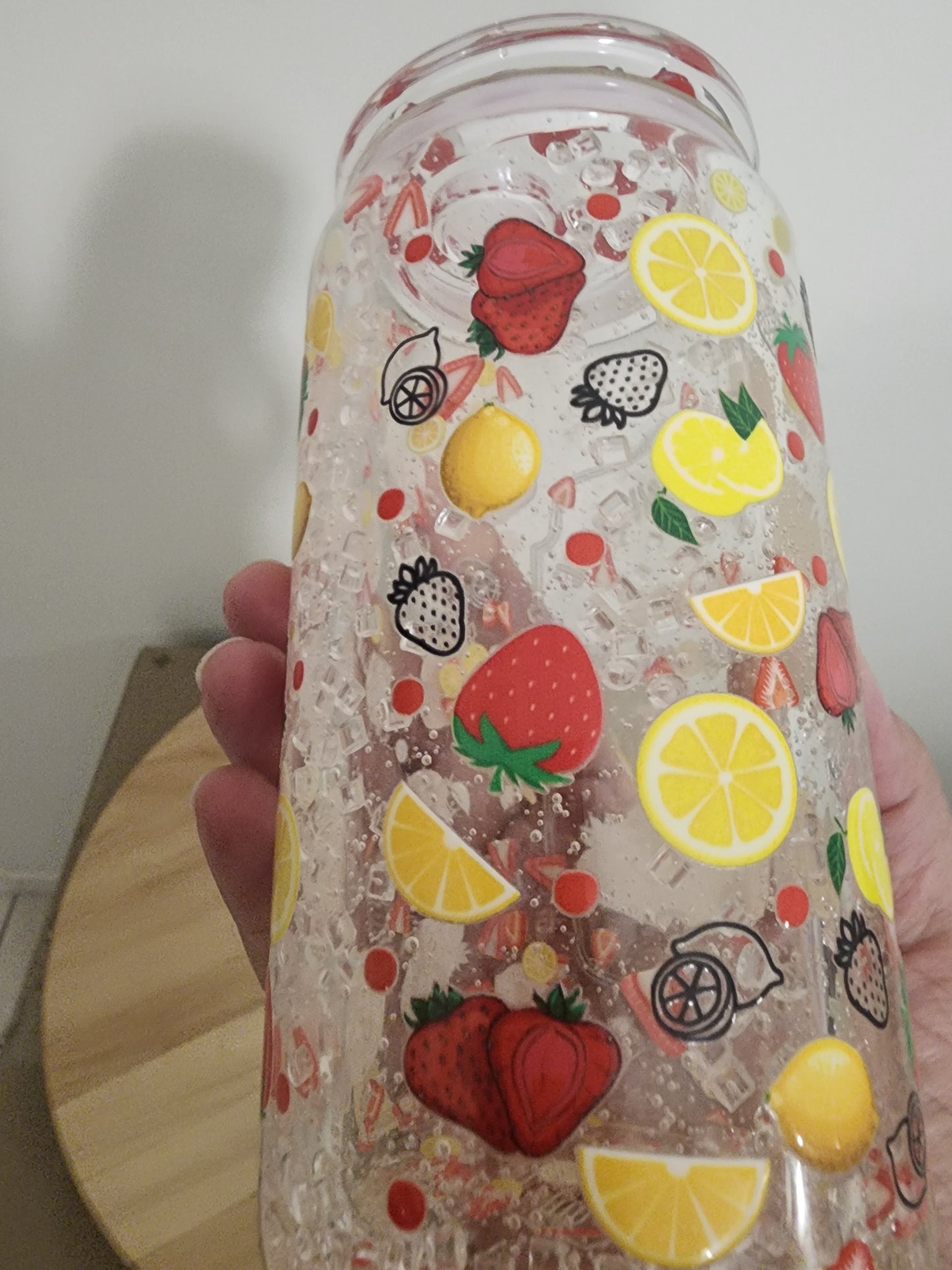 Glass snowglobe. Strawberries and lemons