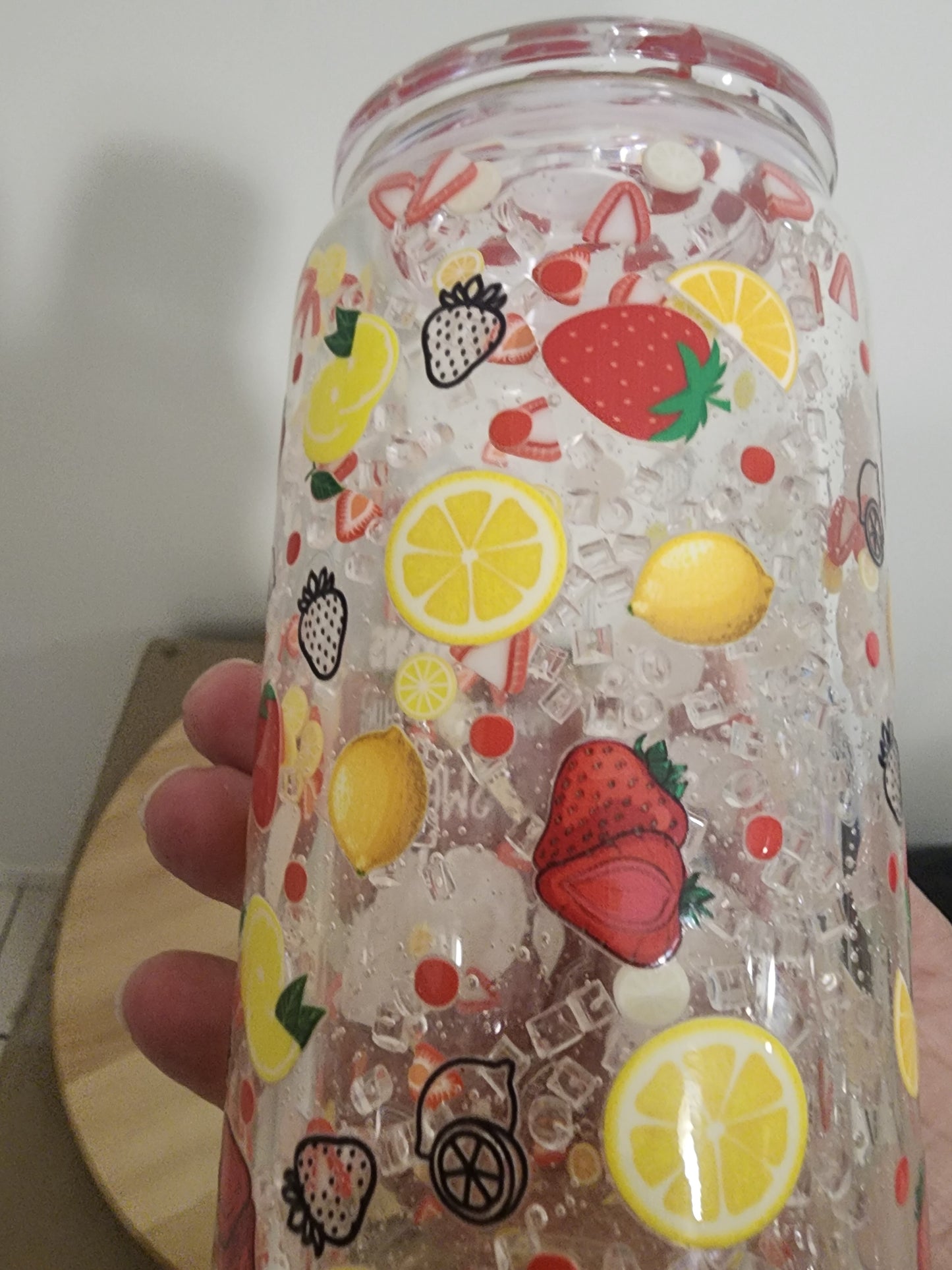 Glass snowglobe. Strawberries and lemons